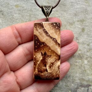 Rectangular wooden pendant featuring a Fox Spirit gazing up at the Northern Lights