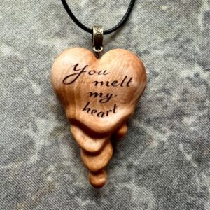 wooden heart pendant that looks like it's melting