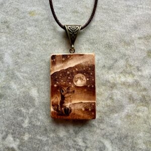 Rectangular wooden pendant featuring a Fox Spirit gazing up at the Northern Lights