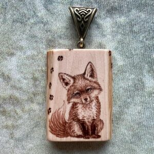 small apple wooden pendant with the image of a cute baby fox on it