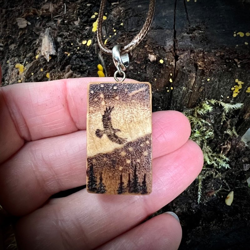 Aurora pendant with a flying bird in a starry sky