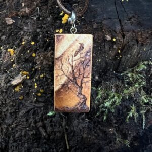 Rectangular wooden pendant featuring a gnarly tree with a bird gazing up at the Northern Lights