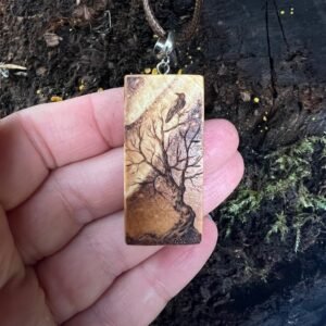 Rectangular wooden pendant featuring a gnarly tree with a bird gazing up at the Northern Lights